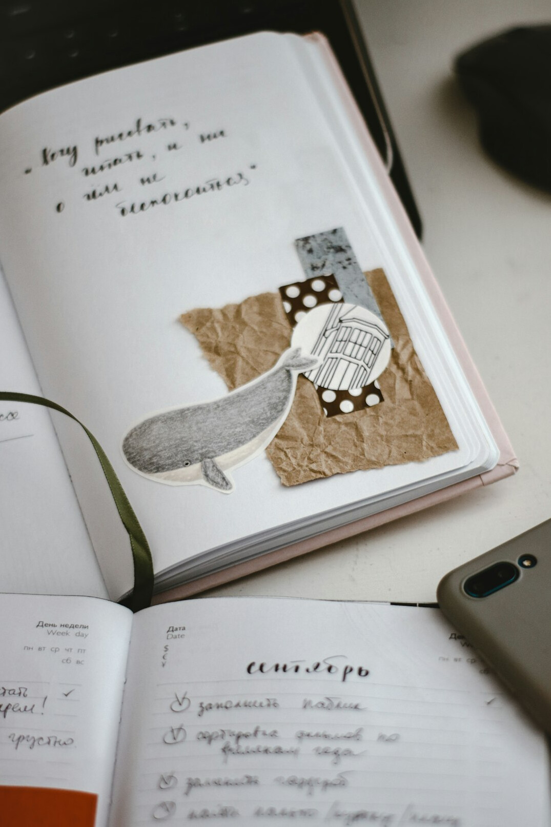 Open notebook with handwritten notes next to a laptop