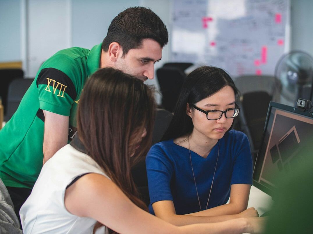 group of friends coding together