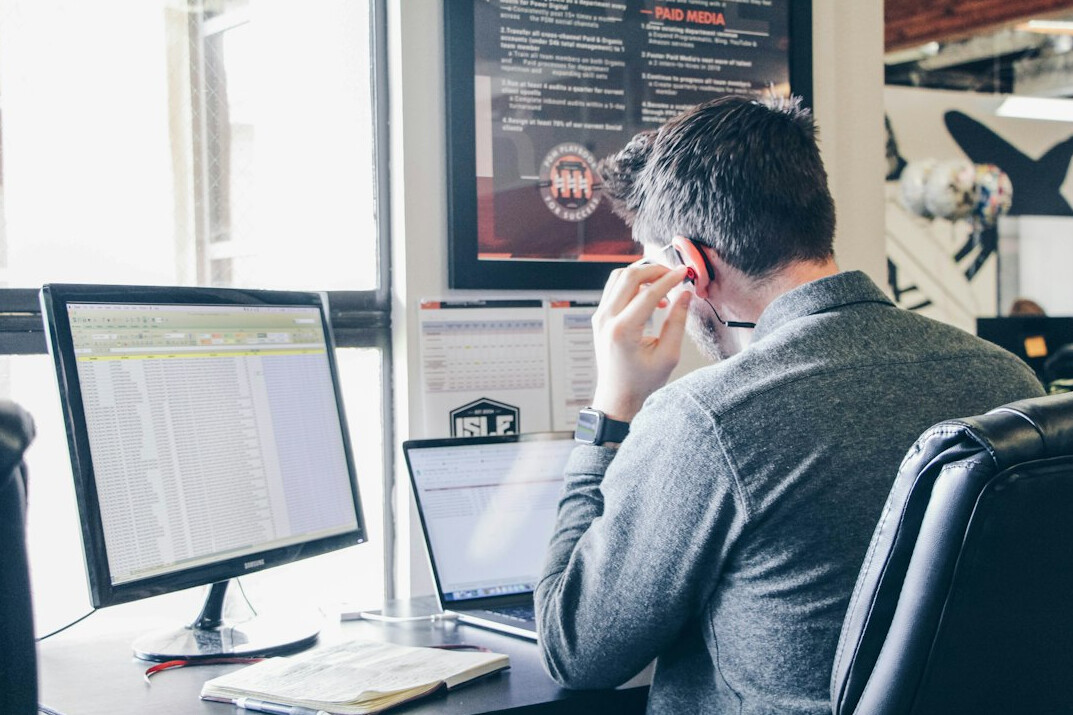 young man coding on laptop