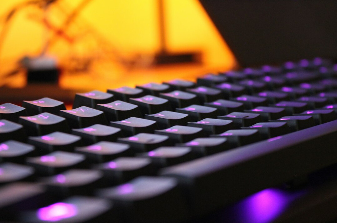 Close-up of hands typing on a mechanical keyboard
